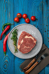 Raw Meat Sliced Pieces Of Beef With Spices And Herbs on a round plate