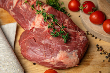Raw Meat Sliced Pieces Of Beef With Spices And Herbs On A Wooden Board 