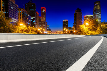 Fototapeta na wymiar Empty asphalt road and modern cityscape in Beijing at night,China.