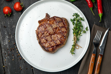 grilled steak on a white round plate.
