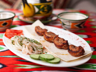 chicken kebab - charcoal grilled chicken breast.Served with vegetables, pickled onions, lavash bread and oriental sauce