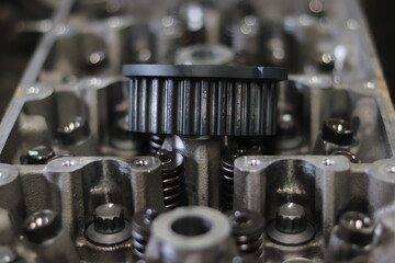 The mechanic is checking the engine.