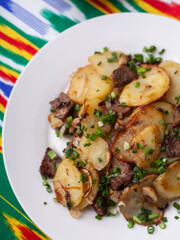  Fried potatoes with pieces of meat. Asian style