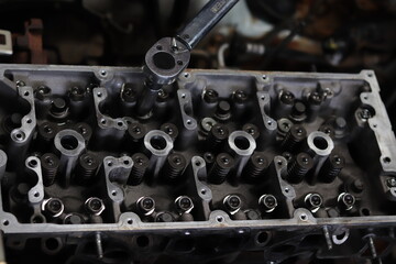 The mechanic is checking the engine.