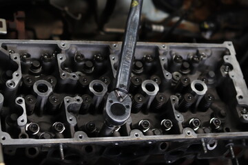 The mechanic is checking the engine.