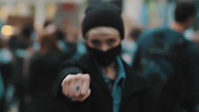 Portrait of fighting young angry rebellion women on the demonstrations punching air with the fist. High quality 4k footage