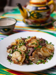  Fried potatoes with pieces of meat. Asian style