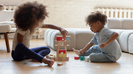 Young architects. Couple of little african children elder school age sister and younger brother...