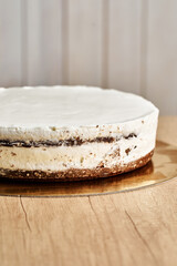 Chocolate Cake. Board with delicious tasty homemade cake on table. Wooden background.