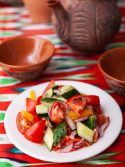 Tomato, cucumber, sweet pepper and onion salad, seasoned with oil. Asian style