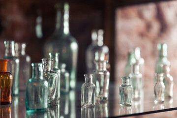 Empty vintage glass vials are on a shelf