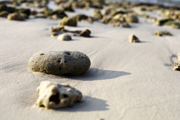 Beautiful Rock and soft wave sea on the beach in Thailand.