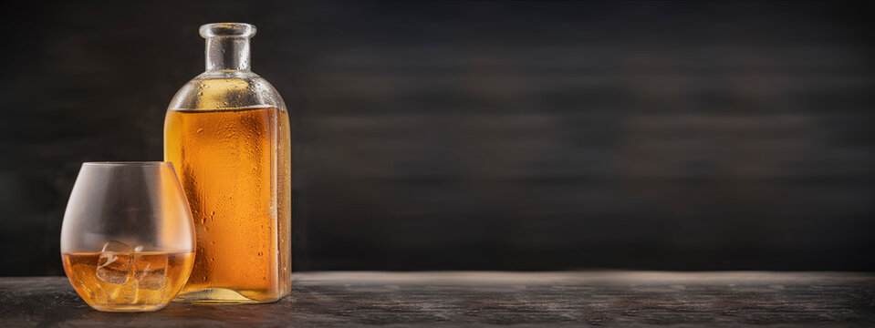 Advertising For The Bar's Website - A Bottle And Glass On The Table With Scotch, Bourbon Or Whiskey. Empty Copy Space, Panoramic Photo