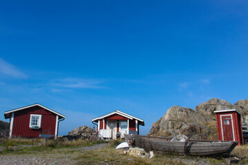 Fototapeta na wymiar Red cottages on the island Harstena in Sweden, principally known for the seal hunting that was once carried out there. It is now a tourist attraction.