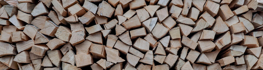 Fototapeta premium Stacks of Firewood. Preparation of firewood for the winter. Pile of Firewood.Firewood background