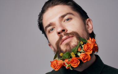 Bearded man flowers In hair close-up emotions