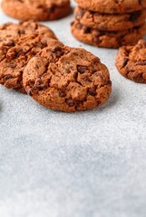 Freshly baked homemade crunchy cookies with chocolate chips, peanut butter or salted caramel. A delicious treat for gourmets. Biscuits close-up. Selective focus, copy space
