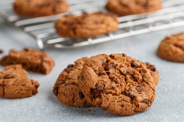 Freshly baked homemade crunchy cookies with chocolate chips, peanut butter or salted caramel. A delicious treat for gourmets. Biscuits close-up. Selective focus, shallow depth of field