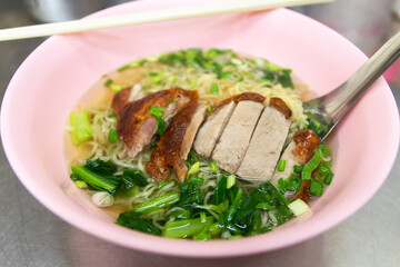 Egg noodle with roast duck in clear soup. 