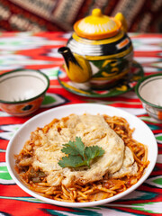  The oriental lagman dish is homemade noodles fried with meat, vegetables and herbs. Eastern cuisine