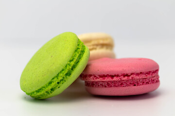 Macaroons isolated on the white background.Homemade french style colorful macaroons. Green, white, pink cookies.