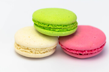 Fototapeta na wymiar Macaroons isolated on the white background.Homemade french style colorful macaroons. Green, white, pink cookies.