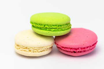 Macaroons isolated on the white background.Homemade french style colorful macaroons. Green, white, pink cookies.