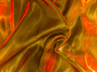 Fabric texture with lighting elements. Beautiful texture of molten gold. Liquid hot gold dough.