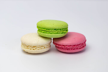 Macaroons isolated on the white background.Homemade french style colorful macaroons. Green, white, pink cookies.