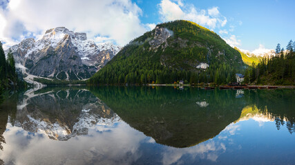 Panoramic view of Mount Seekofel mirroring in the clear calm water of iconic mountain lake Pragser Wildsee (Lago di Braies) in Italy, Dolomites, Unesco World Heritage, South Tyrol