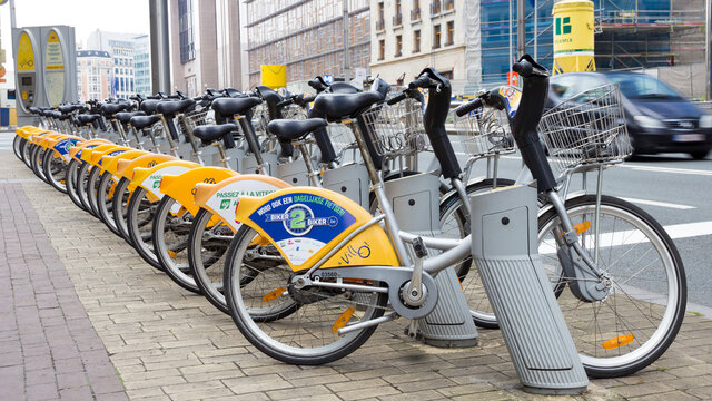  Yellow bicycles of self-service Villo for rent in historical center of Brussels. Bruxelles, Belgium