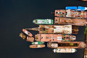 Old rusty ships moored in the harbor. Aerial top down view