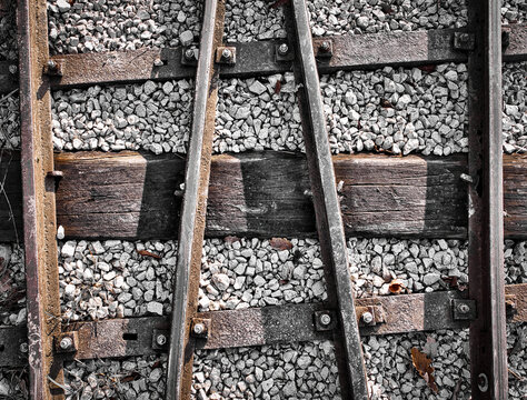 Top-Down Detail of Rusty Narrow-Gauge Railway Tracks on Wooden Sleepers and Gravel in Slovakia