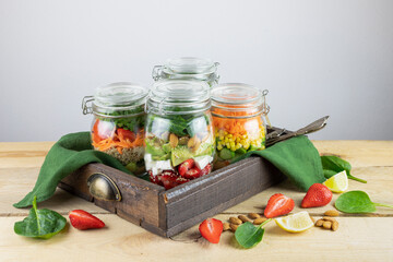 Healthy vegetarian Homemade Mason Jar fresh Salad with Chickpea, strawberry and Veggies on a light background.Diet, Detox, Clean Eating, Vegan raw food concept.