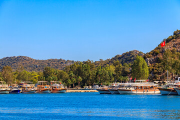 Fototapeta premium Port with tourist boats on the Mediterranean sea coast in Turkey