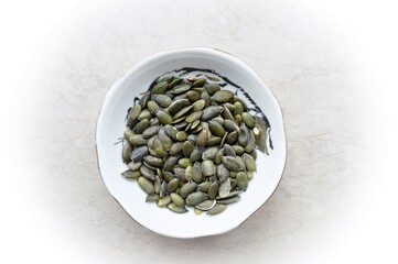 Pumpkin seeds in a white dish