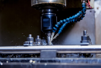 CNC milling machine drills holes in the pipe.