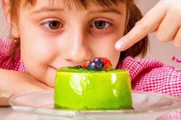 Close up beautiful young girl eating cake, she prefer sweets than healthy food and fruit. Healthy and rubbish food concept.