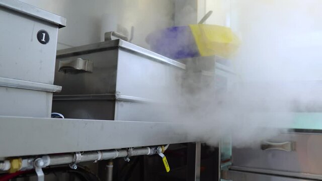 Cooking Crab On Steamer With Smoke And Steam In Kitchen Of Seafood Restaurant. - wide shot