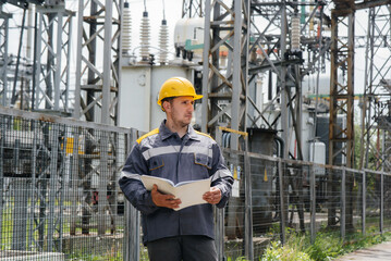 The energy engineer inspects the equipment of the substation. Power engineering. Industry