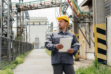 The energy engineer inspects the equipment of the substation. Power engineering. Industry