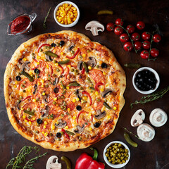 Assorted pizza with mushrooms, champignons, corn, pepper, red sauce, cherry tomatoes. flying vegetables concept. Product levitation