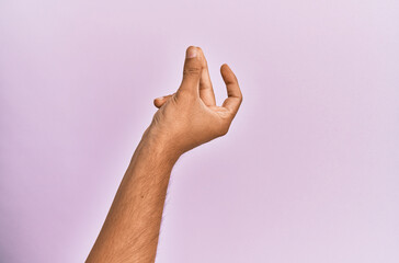 Arm and hand of caucasian young man over pink isolated background snapping fingers for success,...