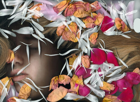 Gentle portrait of a girl with long blond hair in flower petals.Using scanography.