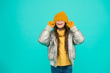 funny kid in silver puffer jacket and knitwear get warm in winter ready for activity on holidays, having fun © be free