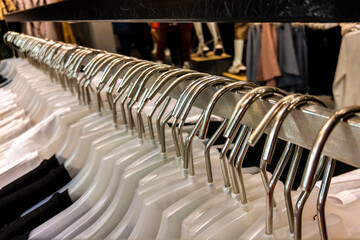 Hangers with clothes in a row in the store. Things on hangers.