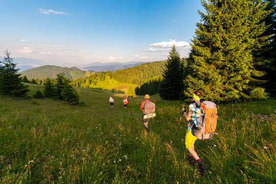 Group of backpackers trekking in sunset light, Velka Fatra, Western Carpathians, Slovakia