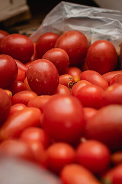 caj&oacute;n de frutas y verduras naranja zapallito verde banana manzana en verduler&iacute;a con fondo oscuro c&oacute;rdoba argentina