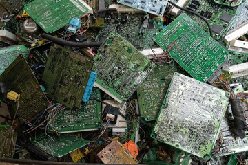 Scrap yard printed circuit board electronic waste for recycling with selective focus. main board...