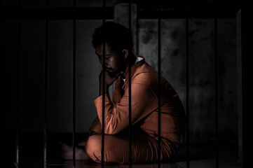 Asian man desperate at the iron prison,prisoner concept,thailand people,Hope to be free,Serious...